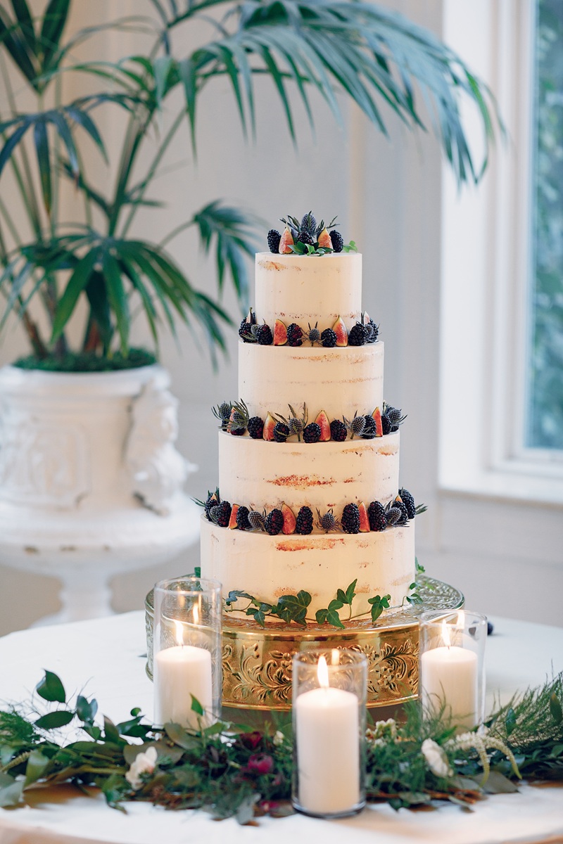 Elegantly dressed guests celebrating together at an upscale birthday party with styled cake and balloon backdrop