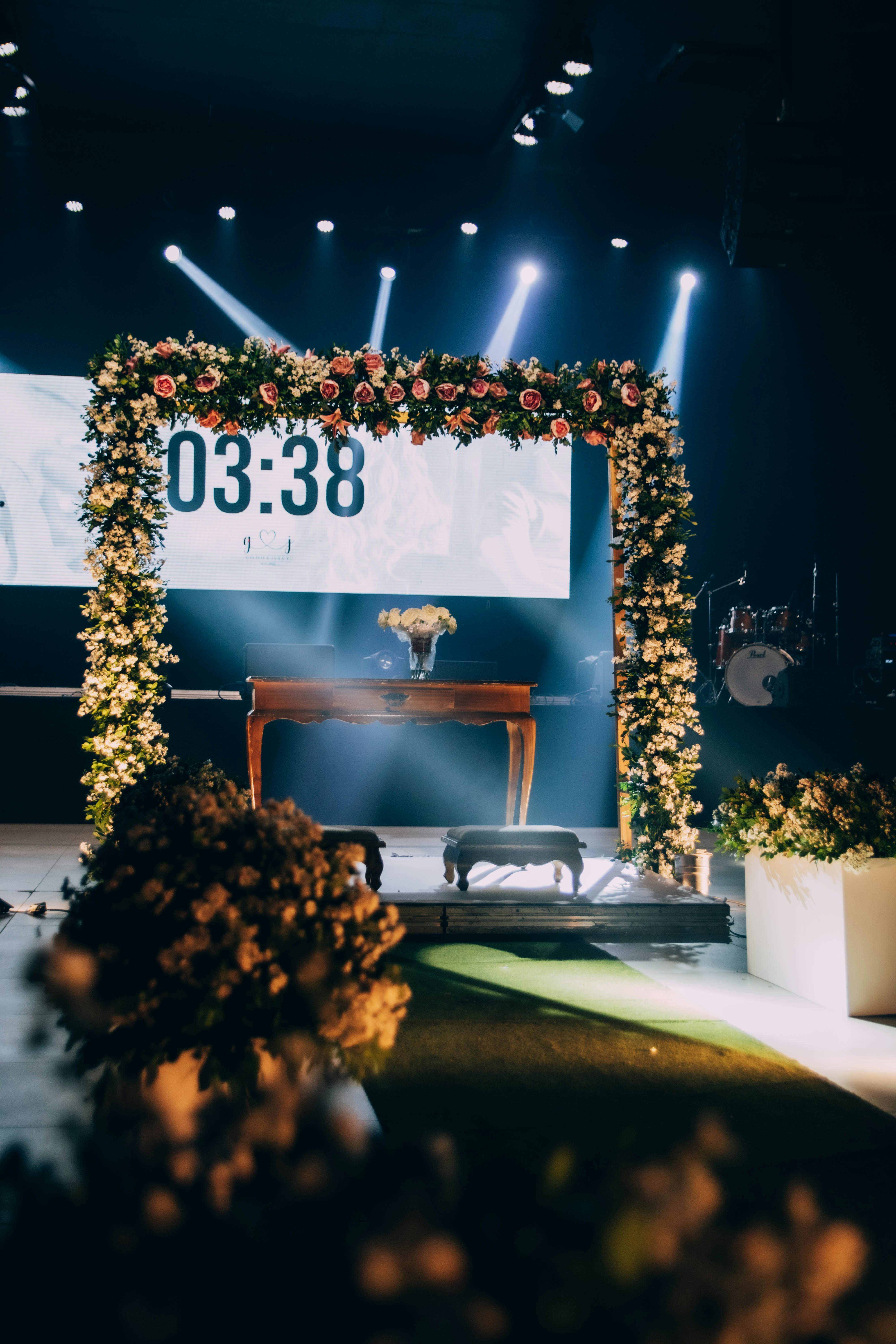 Performer on a lit stage at a branded product launch event with attendees in the foreground